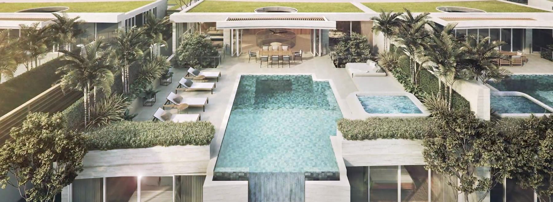 Computer-generated still from the developer's film of Banyan Tree Beach Residences Aegir villas from above, their rooftop pools and terraces among the trees