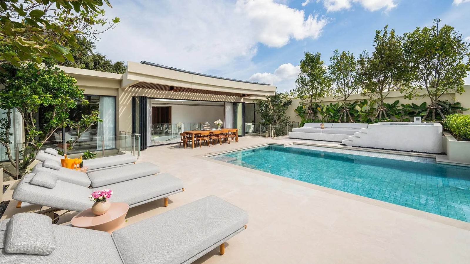 Computer-generated render of a villa terrace at Banyan Tree Beach Residences Aegir, a long private pool with loungers, the dining terrace and the villa behind