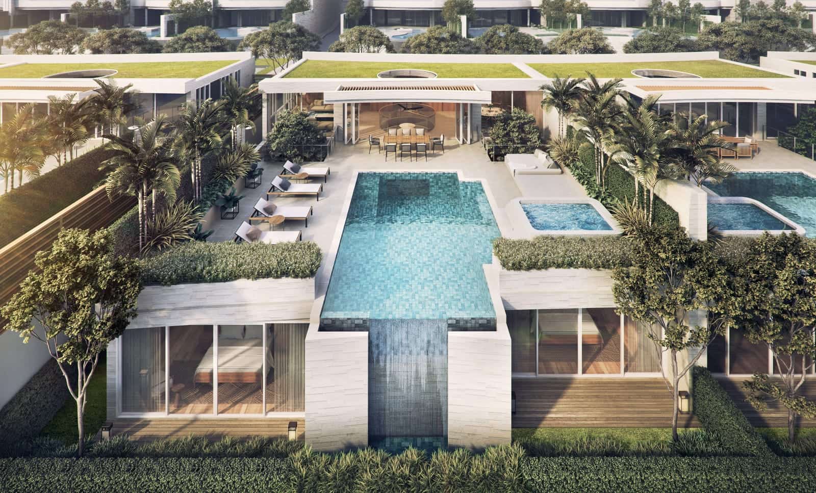 从海的一侧高处望向 Banyan Tree Beach Residences Aegir 两栋别墅的效果图:上层的泳池悬于玻璃幕墙的下层之上,屋顶有绿化