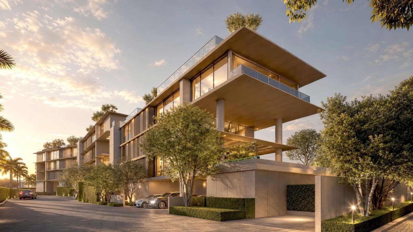 Визуализация уличного фасада Banyan Tree Beach Residences Nerea в сумерках: невысокие здания с консольными плитами крыш и озеленёнными террасами