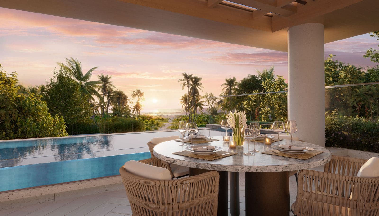 Render of a round dining table on a terrace beside a pool at Banyan Tree Beach Residences Nerea at sunset