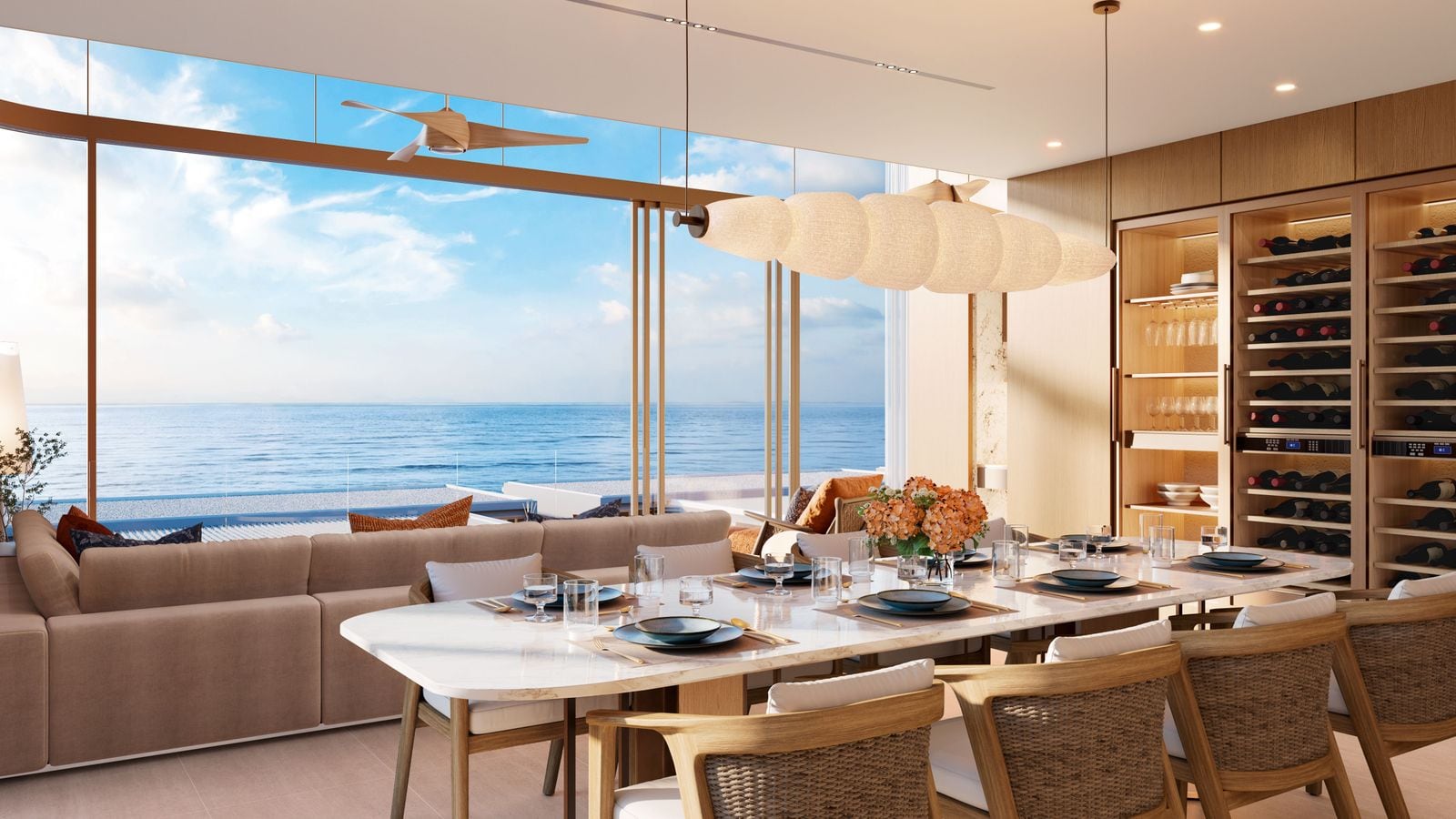 ภาพจำลองโต๊ะรับประทานอาหารและผนังเก็บไวน์ของทาวน์โฮมที่ Banyan Tree Beach Residences Varuna มีทะเลอยู่ไกลออกไป