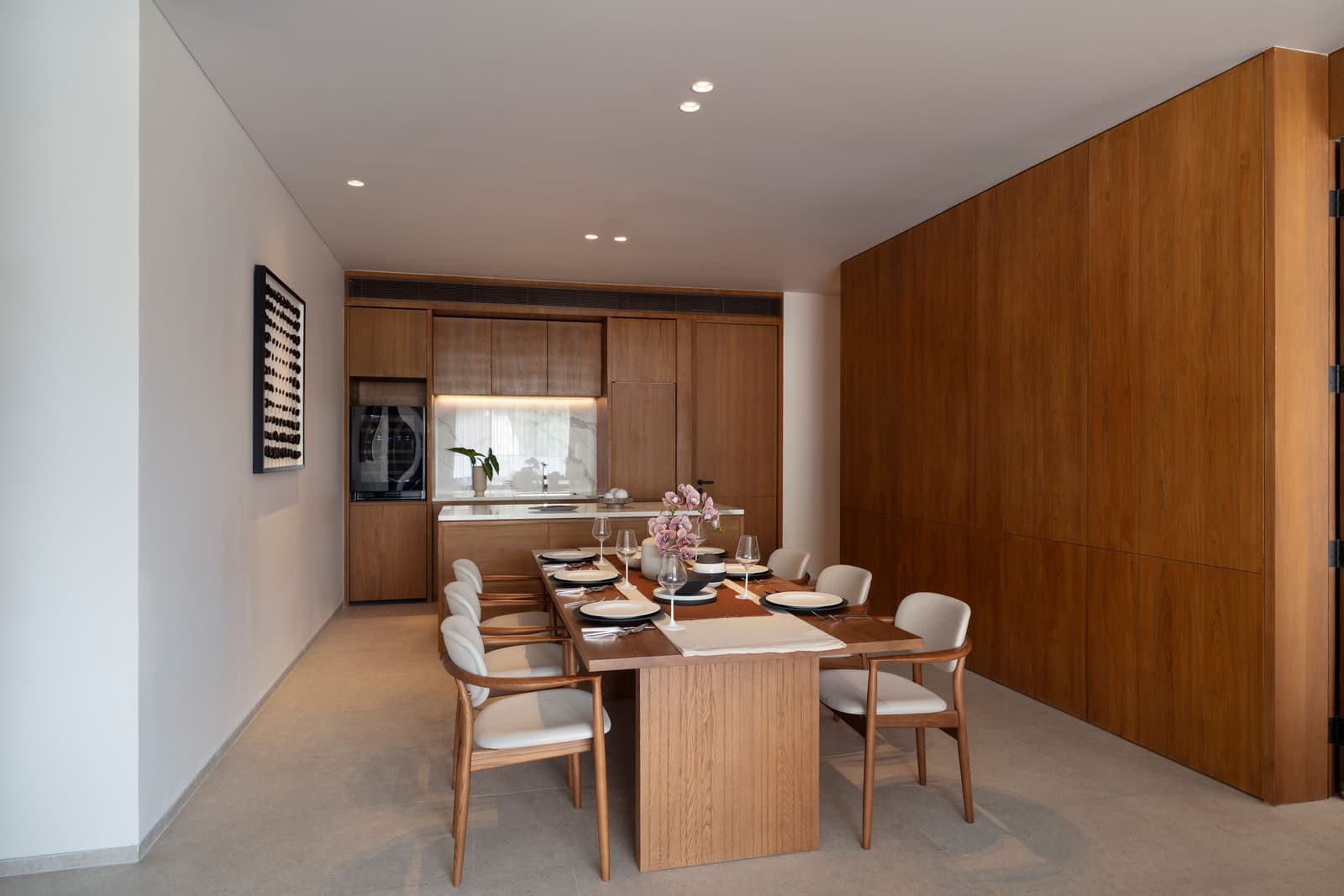 Dining room and kitchen of the three-bedroom show condominium at Kiara Reserve Residences, Phuket