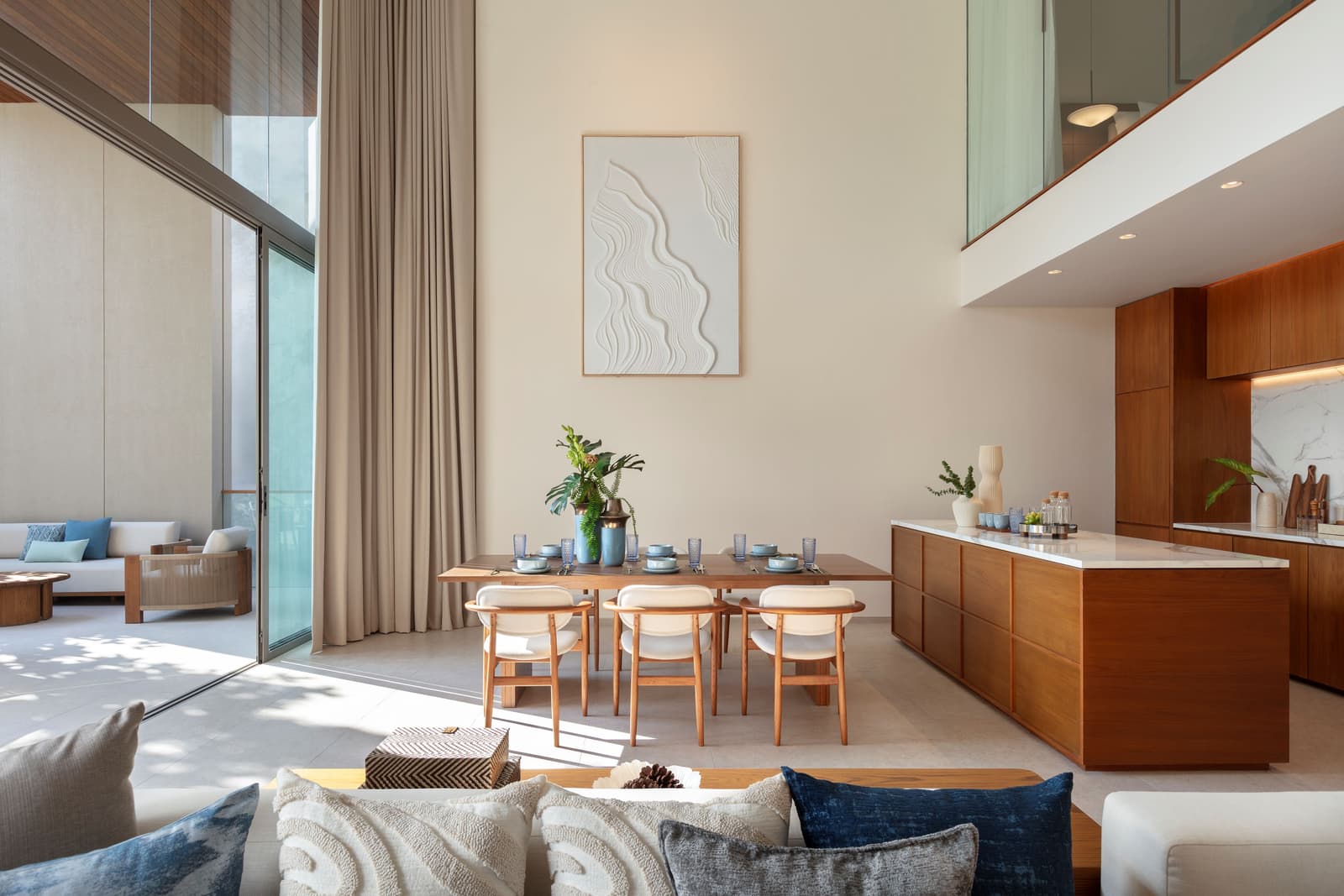Dining room of the three-bedroom duplex show condominium at Kiara Reserve Residences, Phuket, with the stair to the bedroom floor