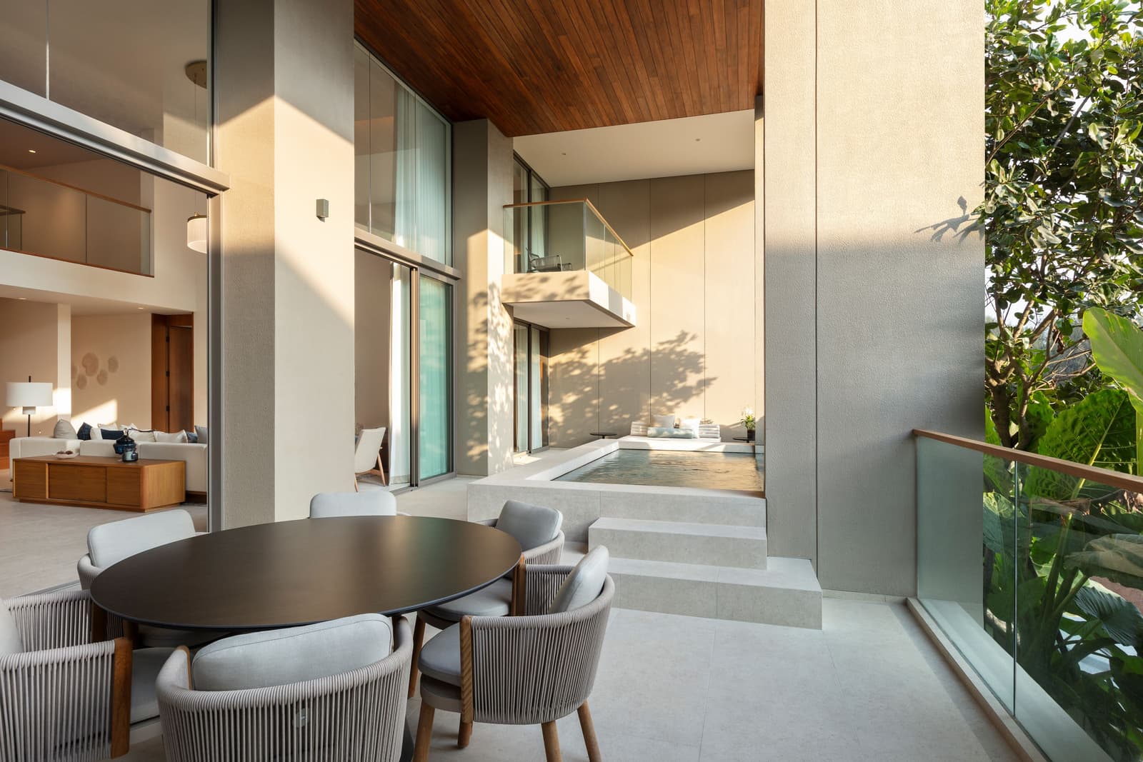 Terrace of the three-bedroom duplex show condominium at Kiara Reserve Residences, Phuket, with a dining table and a jacuzzi pool