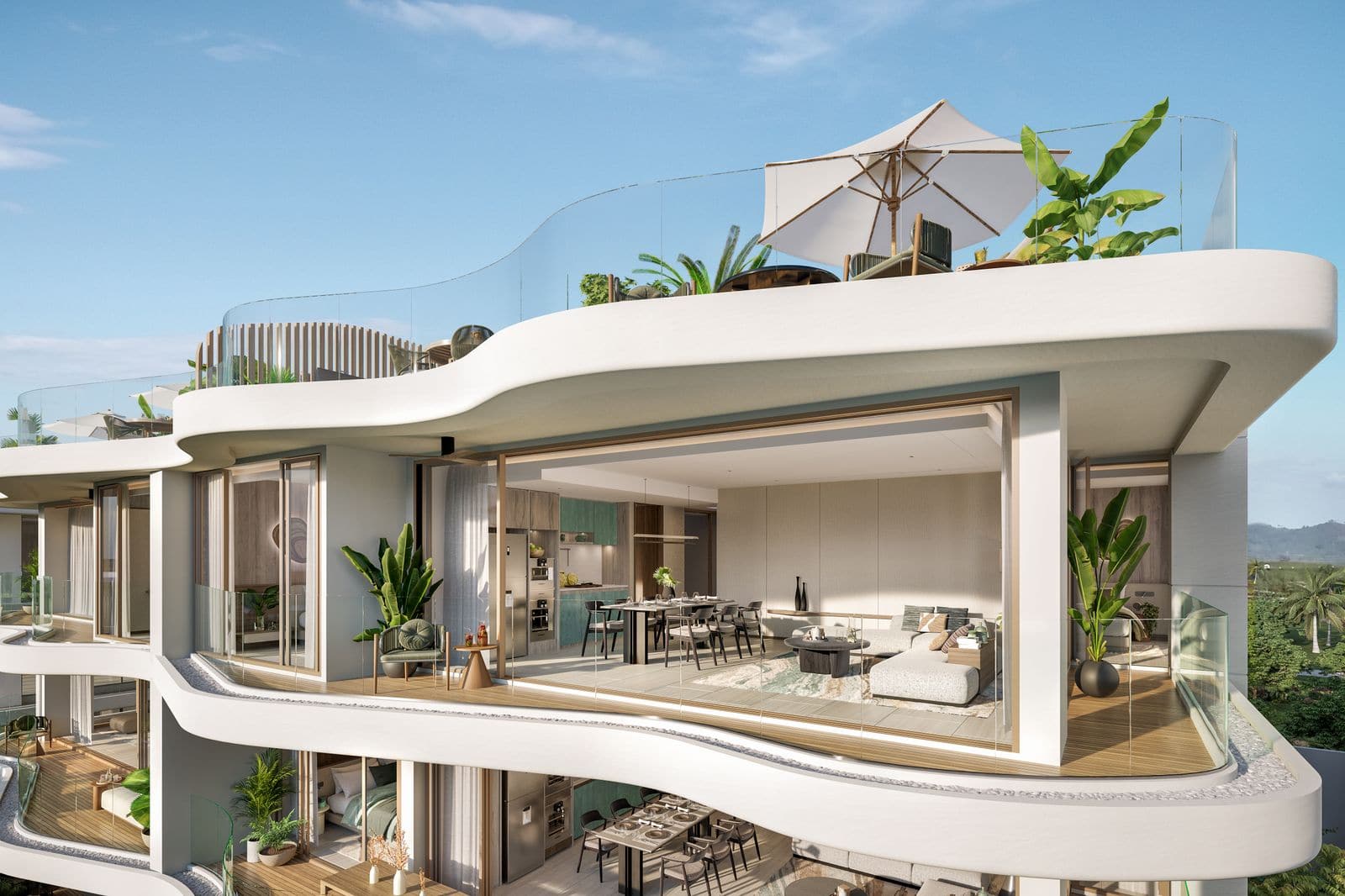 從外面看 Residences at Garrya Phuket 頂層單位的電腦效果圖:玻璃環繞的客廳之上,是放著太陽傘與植物的弧形天台平台