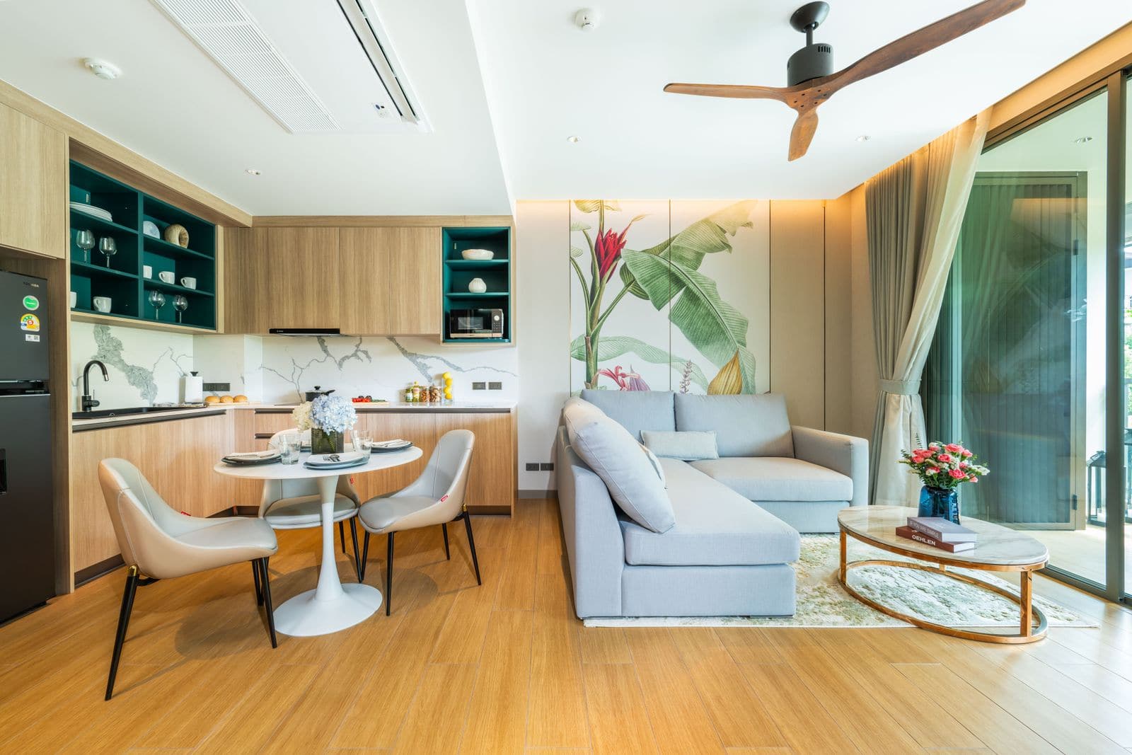 Photograph of the living area and kitchen of the one-bedroom show unit at Skypark Elara Lakelands Phuket