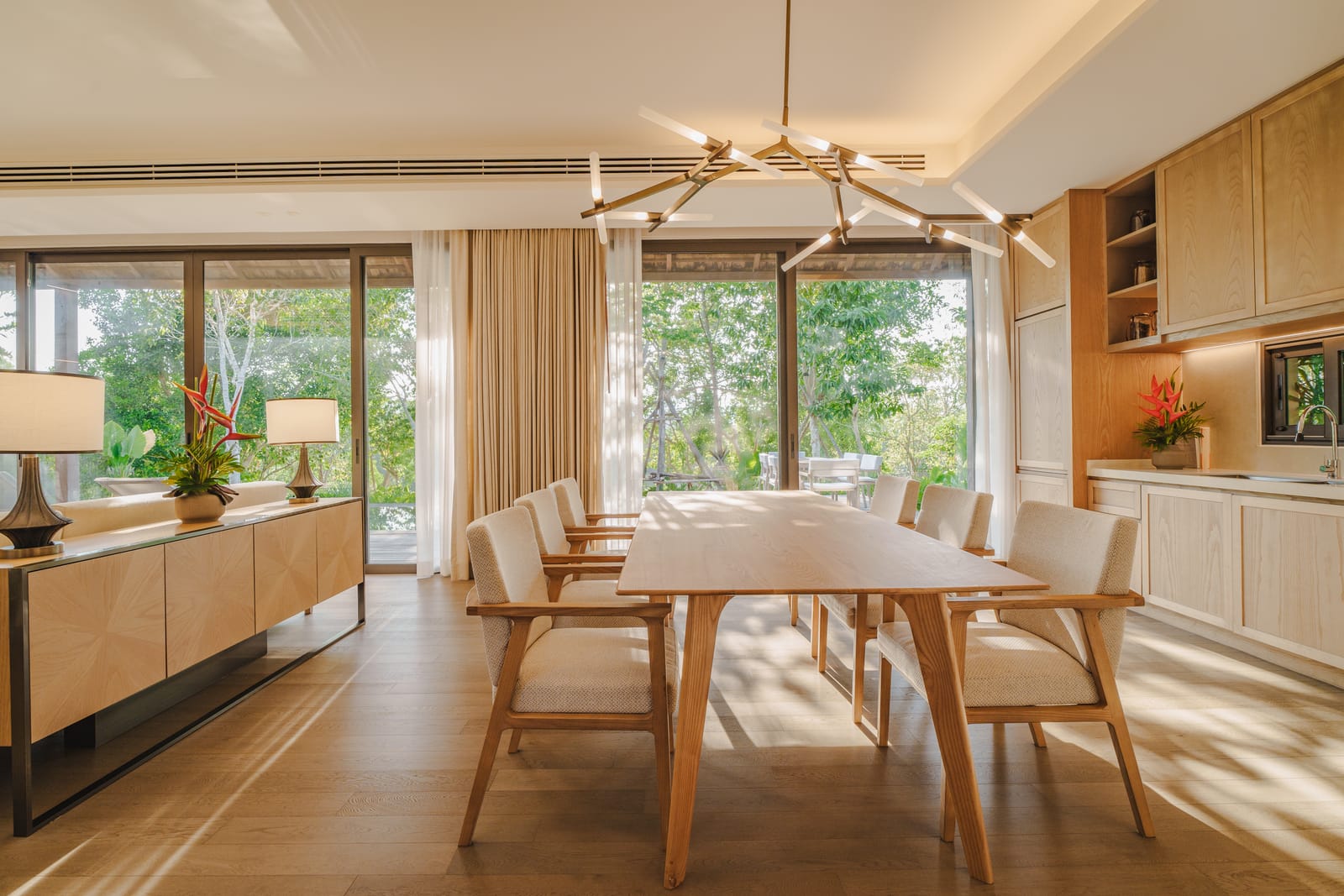 The dining room and kitchen of a finished Vana 3 wooden villa at Tri Vananda, Phuket