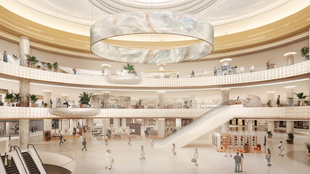 Central Pattana 的效果图:扩建后 Central Phuket Floresta 内的 Pearl Atrium,奶油色圆形中庭,悬挂珍珠般的吊灯,环绕弧形楼层与自动扶梯
