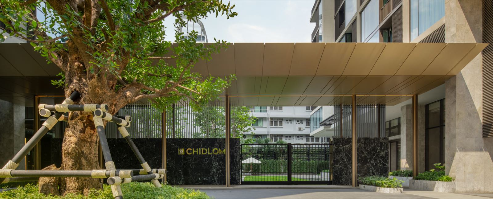 The arrival entrance and heritage tree at 28 Chidlom on Soi Chidlom, central Bangkok