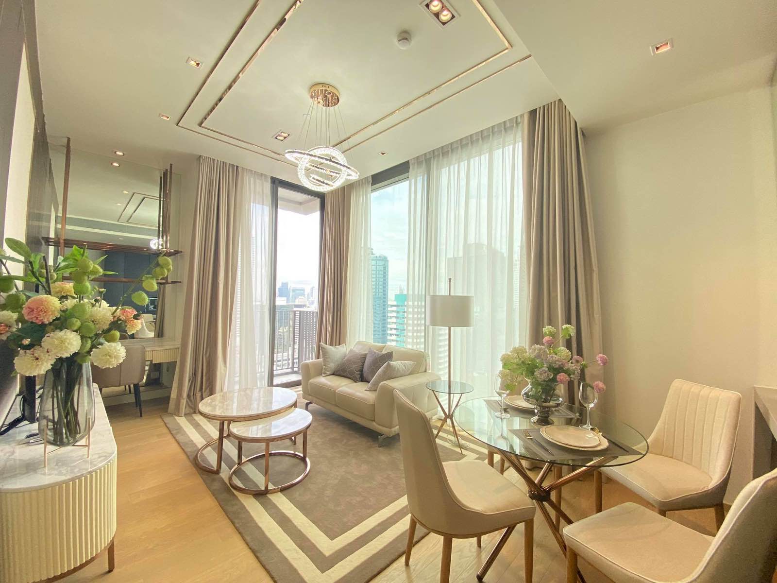 Living and dining room with skyline views in a 28 Chidlom residence, central Bangkok
