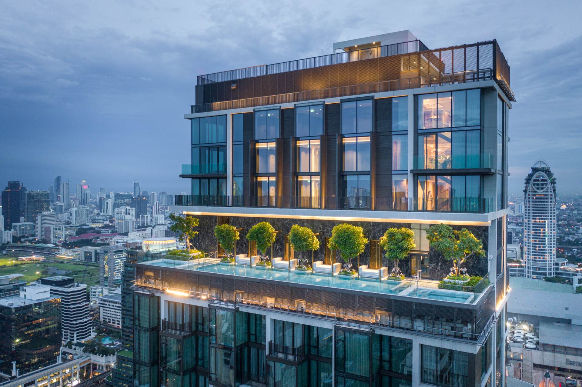 28 Chidlom tower crown and rooftop sky pool at dusk above the Chidlom skyline in central Bangkok, by SC Asset