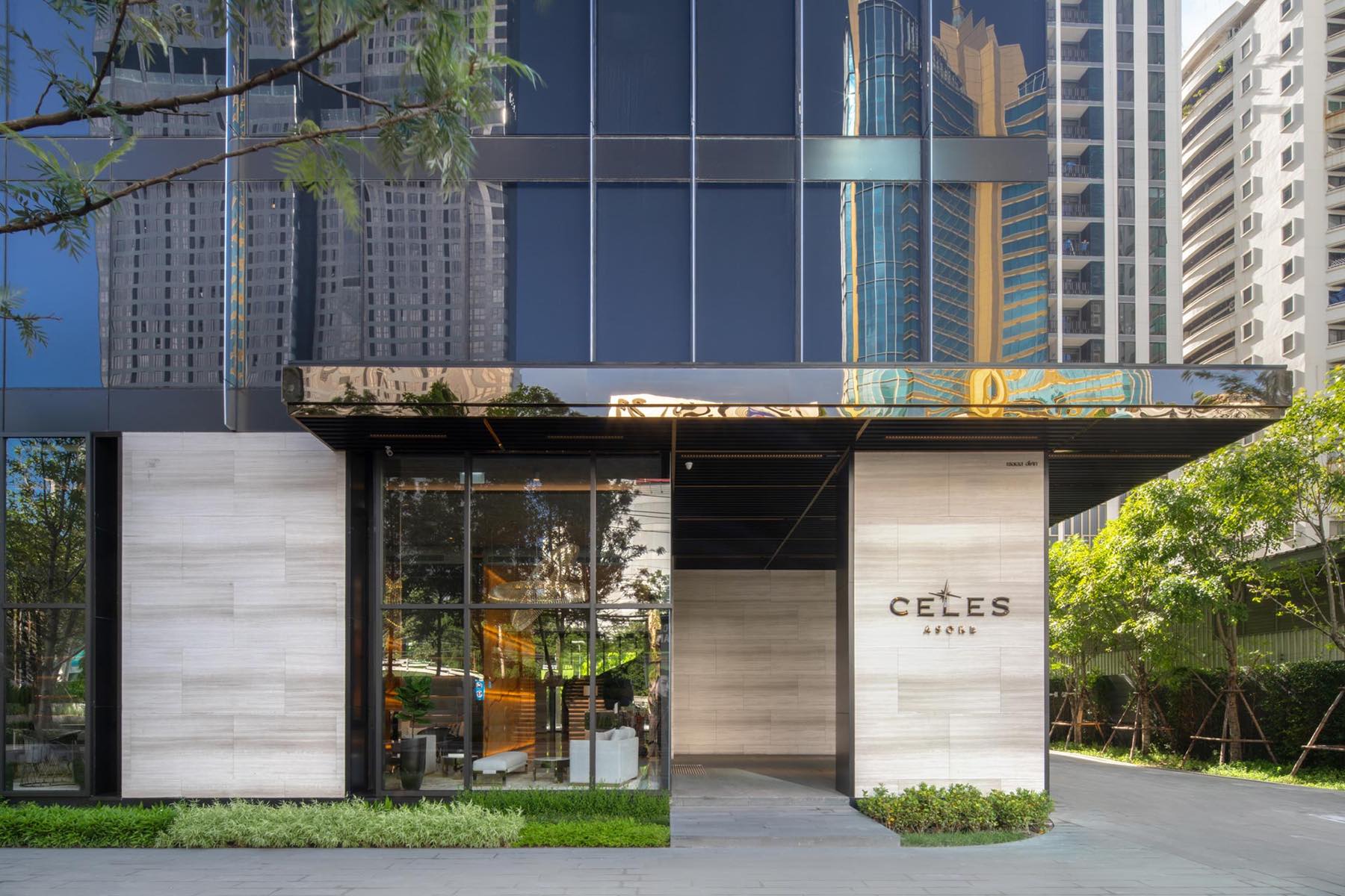 Celes Asoke: arrival entrance with CELES signage and greenery