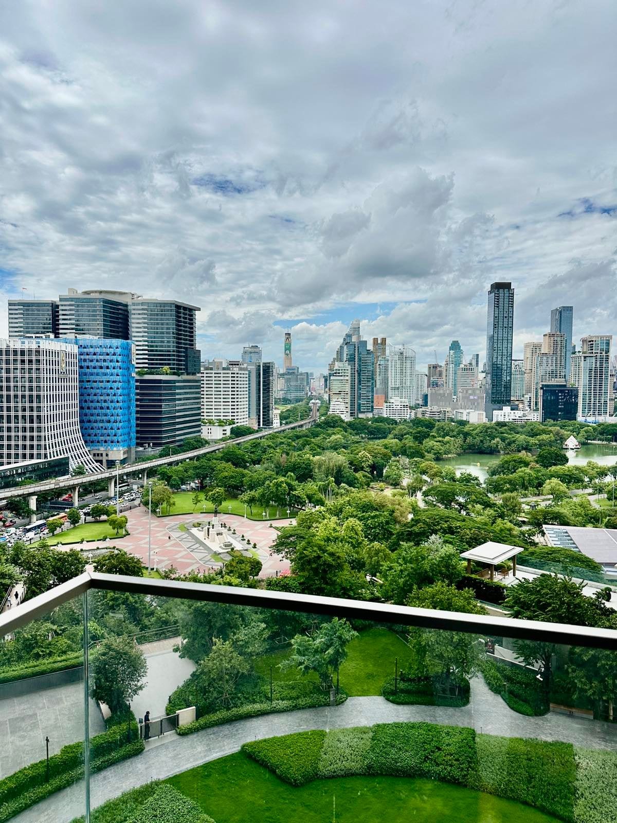 The view from a two-bedroom residence at Dusit Residences Parkside, Bangkok, over the green of Lumphini Park to the Sathorn and Silom towers