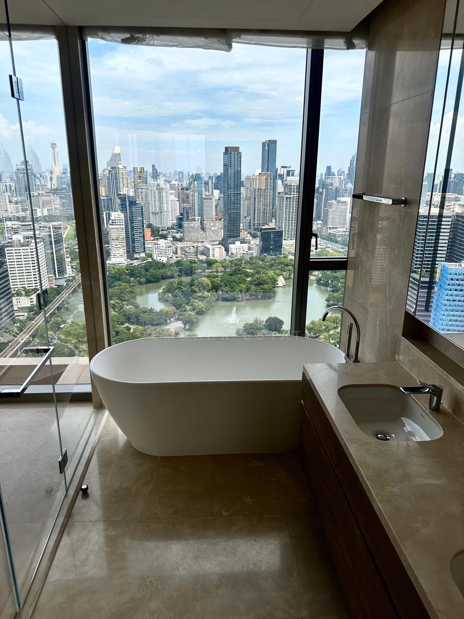 The bathtub in the principal bathroom of unit 3903 at Dusit Residences, Dusit Central Park, looking straight down onto the lake and fountain of Lumphini Park