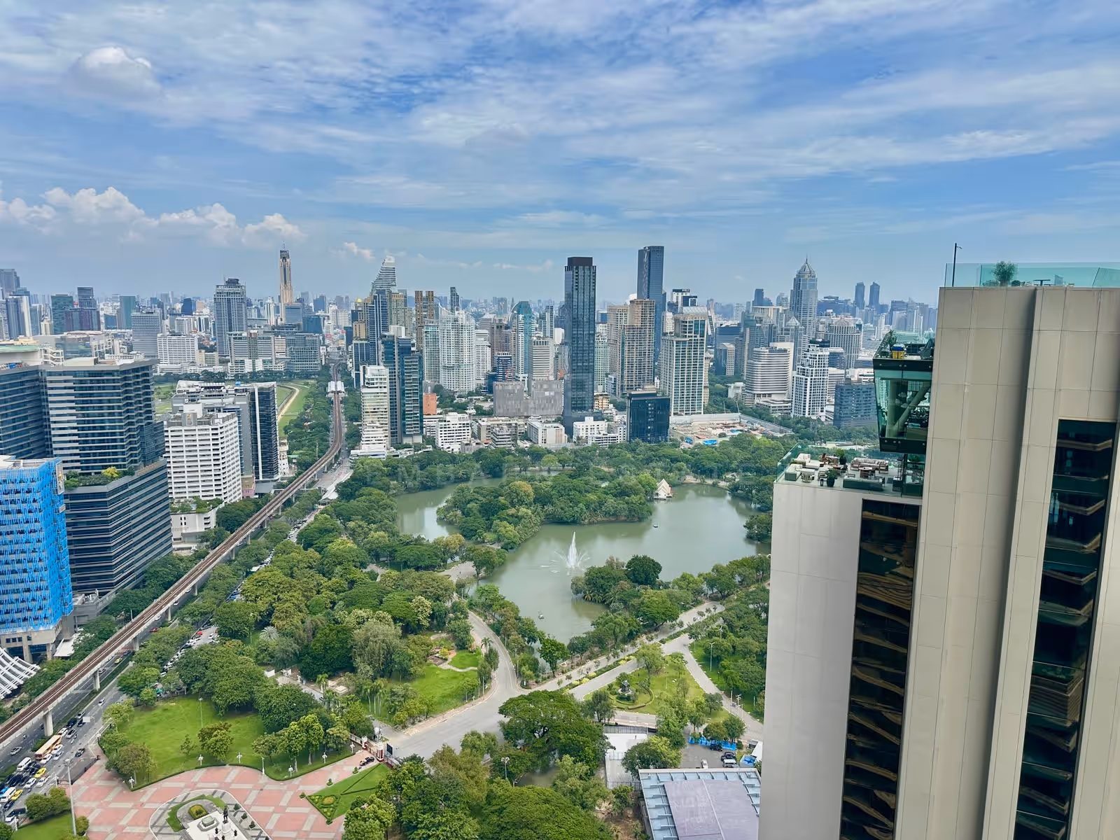 Lumphini Park from unit 3903 at Dusit Residences, Dusit Central Park: the lake and fountain, the skytrain along the park and the skyline beyond