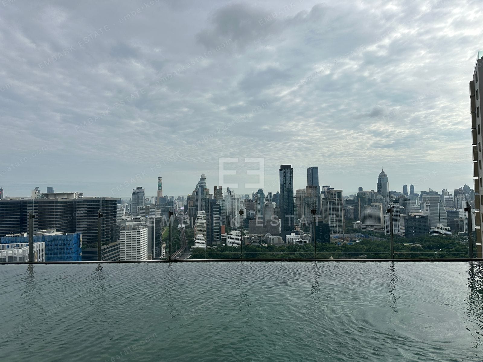 The rooftop infinity pool edge at Dusit Central Park looking out across the central Bangkok skyline, home to Dusit Residences on Rama IV Road