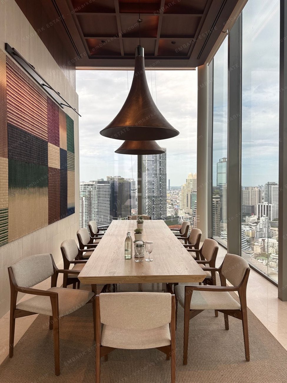 A private dining room at Dusit Central Park with floor-to-ceiling views over the central Bangkok skyline, home to Dusit Residences on Rama IV Road