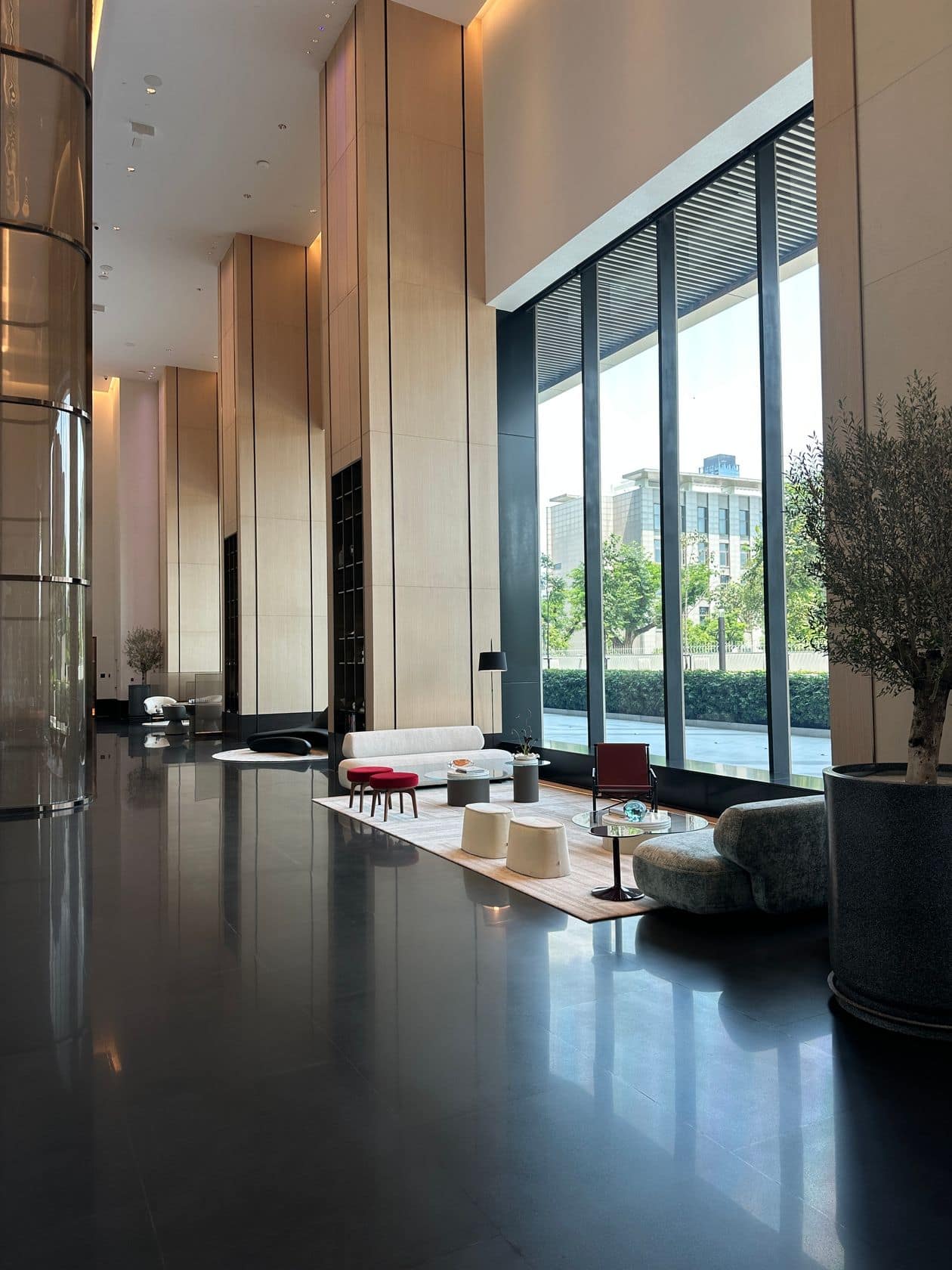 The skylit lobby lounge at EI8HTEEN SEVEN, One Bangkok, with city-view seating
