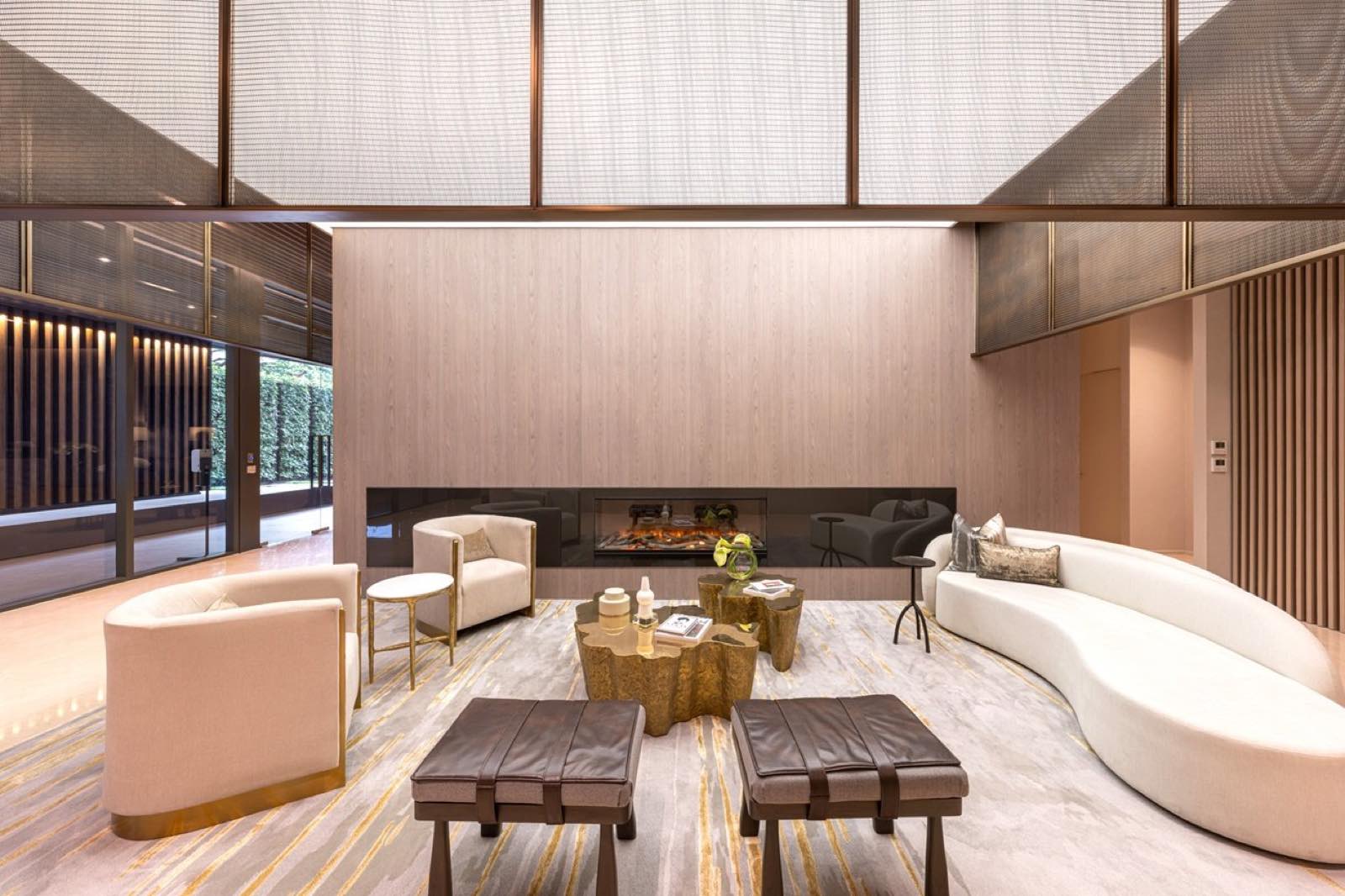The Estelle Phrom Phong: grand residents' lobby lounge with double-height mesh canopy and fireplace