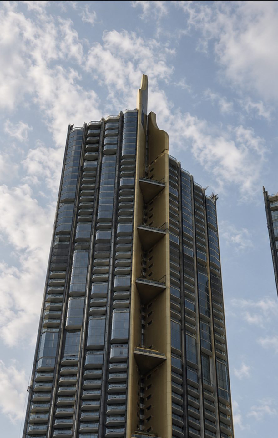 Magnolias Waterfront Residences: the sculptural gold-finned crown of the riverside tower at ICONSIAM against the sky in Bangkok, by MQDC