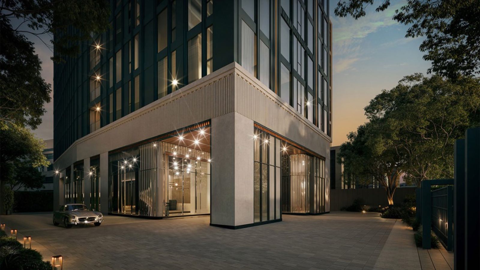 MAVISTA Phrom Phong: ground-floor lobby entrance lit at dusk