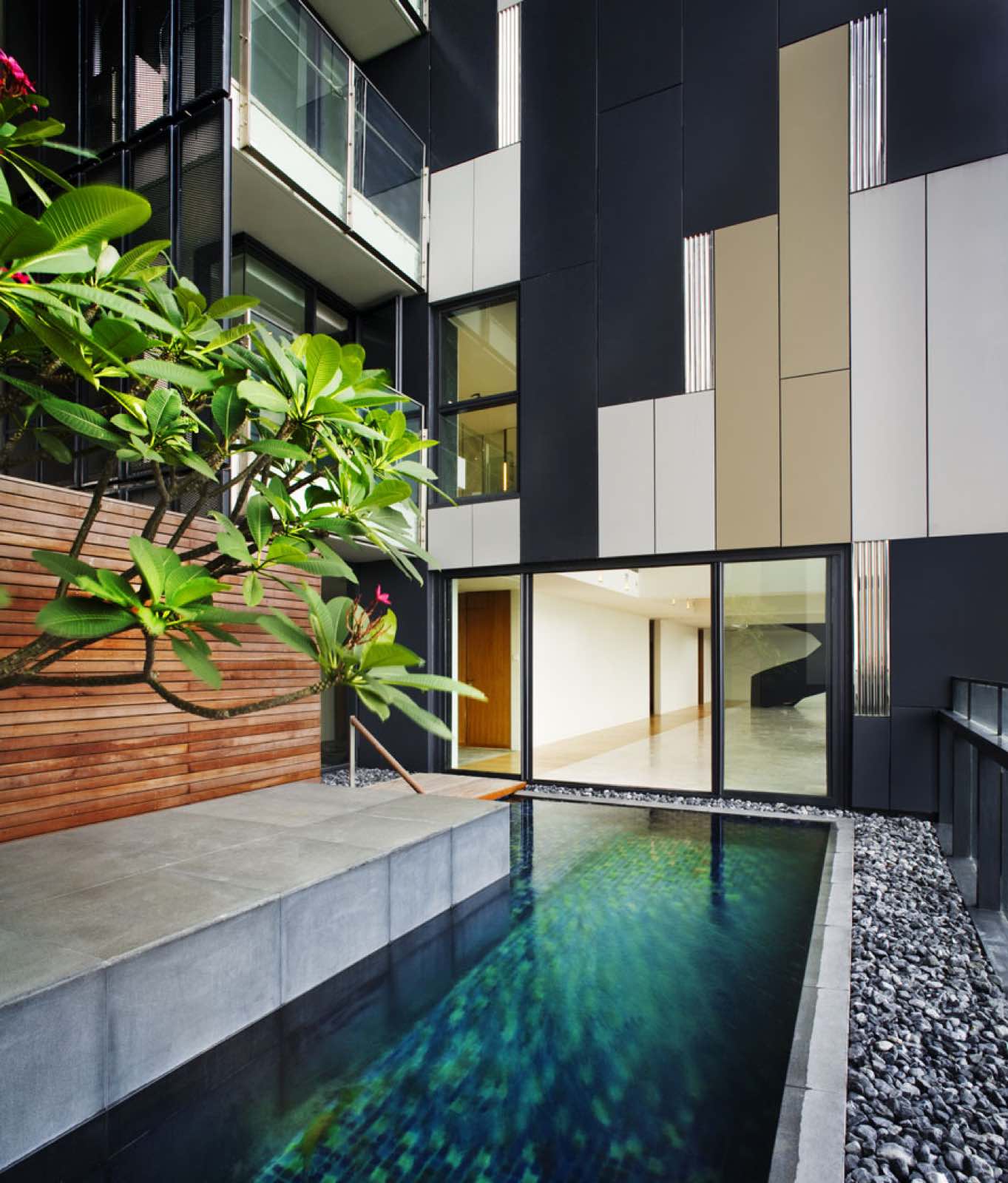The Met Sathorn: Private sky-garden plunge pool against the dark-and-cream Met facade with frangipani planting