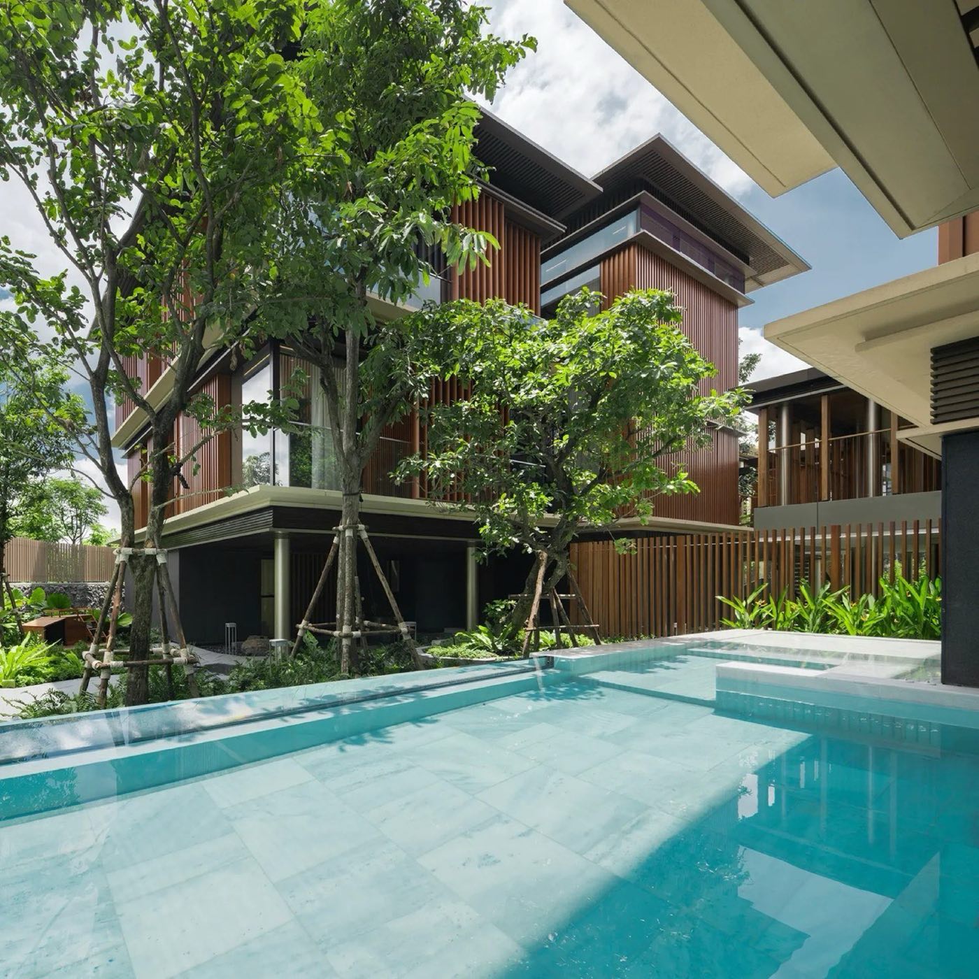 A villa and its private pool among the trees at Mulberry Grove Villas, The Forestias, Bang Na, Bangkok, by MQDC and Foster + Partners
