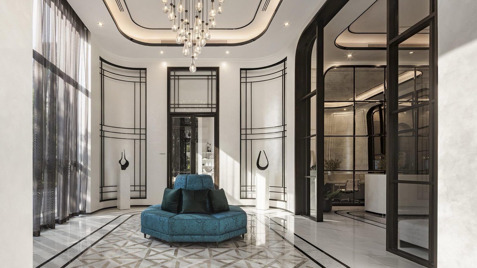 MUNIQ Langsuan: grand lobby with chandelier and blue round sofa