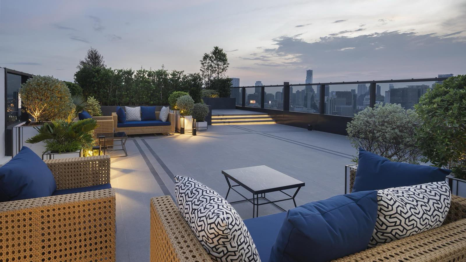 MUNIQ Langsuan: rooftop garden terrace lounge at dusk