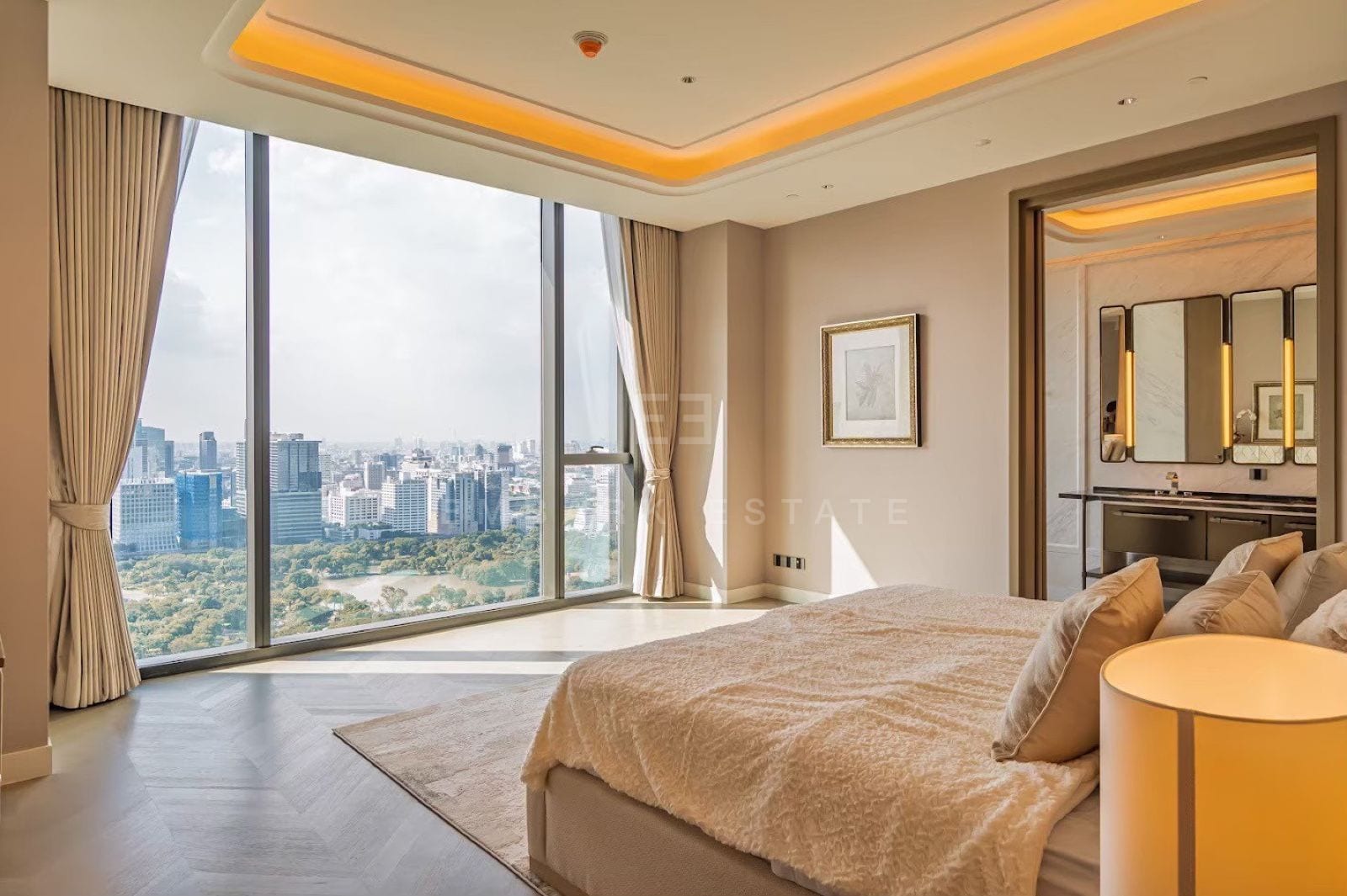 The principal bedroom of a three-bedroom residence at ONE89 Wireless, One Bangkok, with floor-to-ceiling windows over Lumphini Park