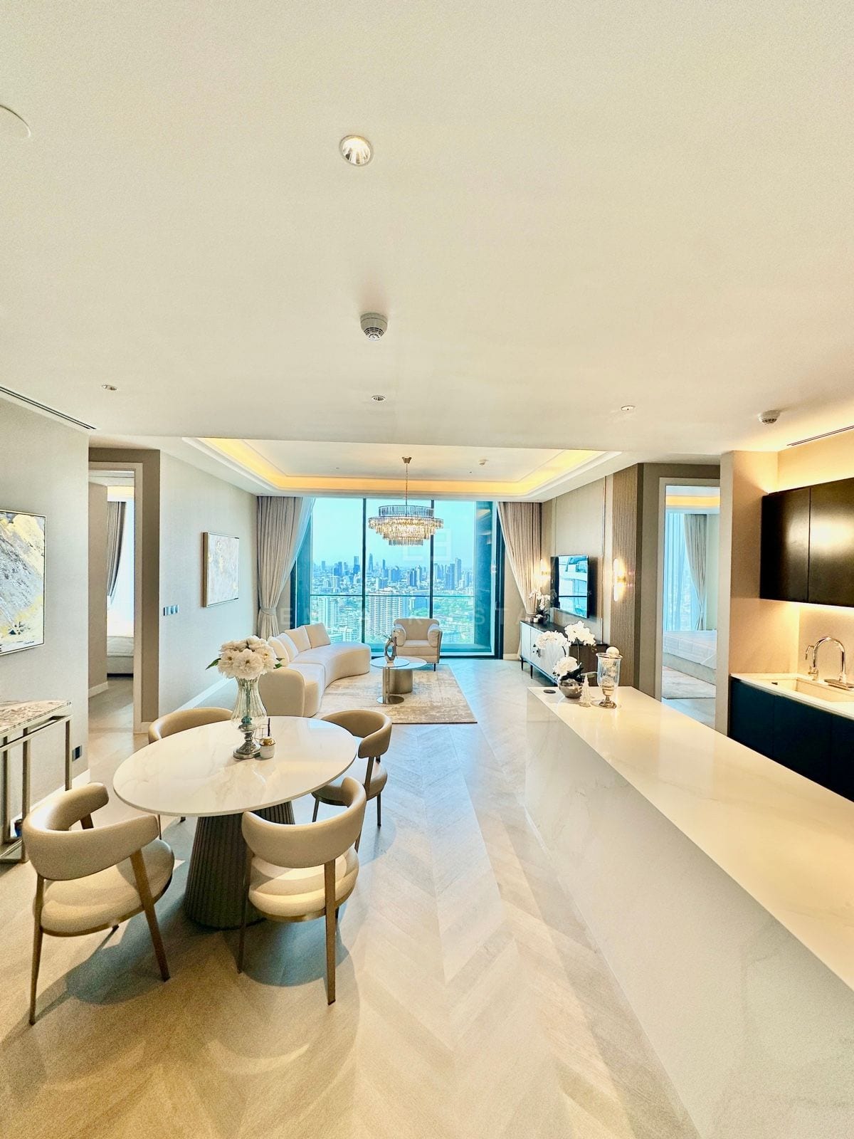 The dining area of a two-bedroom residence at ONE89 Wireless, One Bangkok, set beside floor-to-ceiling windows over the city