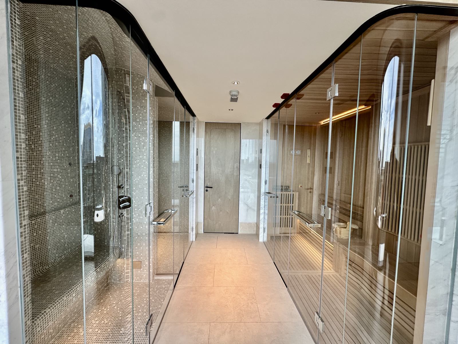 The spa at ONE89 Wireless, One Bangkok, with a mosaic-tiled steam room and a timber sauna, a computer-generated render by One Bangkok