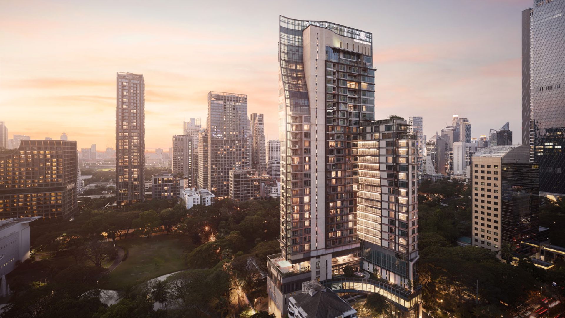 Oriental Residence Bangkok: tower exterior at dusk overlooking Lumphini Park and the Langsuan skyline