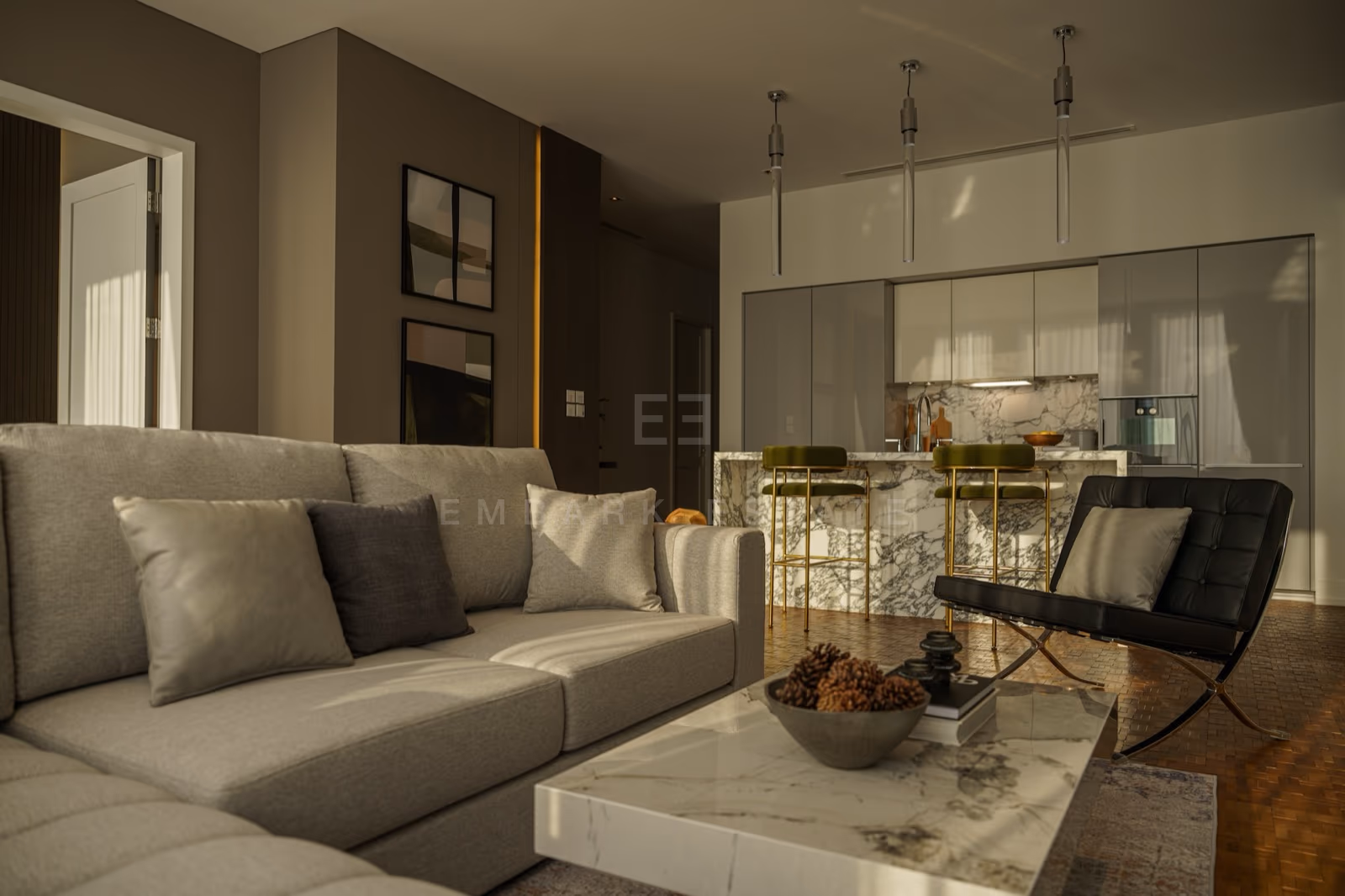 The living room of a two-bedroom residence at The Ritz-Carlton Residences Bangkok looking toward the marble breakfast bar and open kitchen
