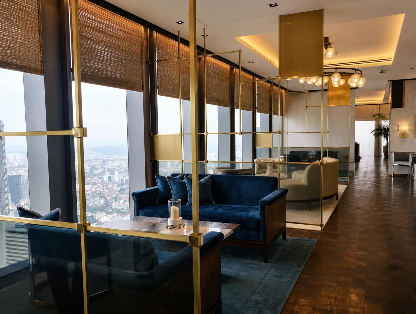 The Ritz-Carlton Residences Bangkok: the sky lounge with blue velvet sofas and brass screens on a high floor overlooking Bangkok