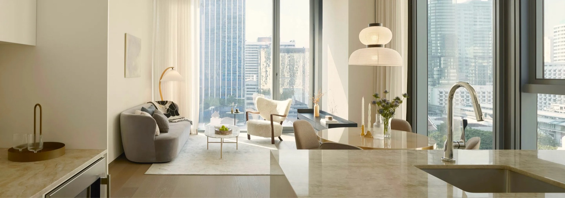 Corner living room and kitchen with city views at Scope Langsuan, Langsuan, Bangkok