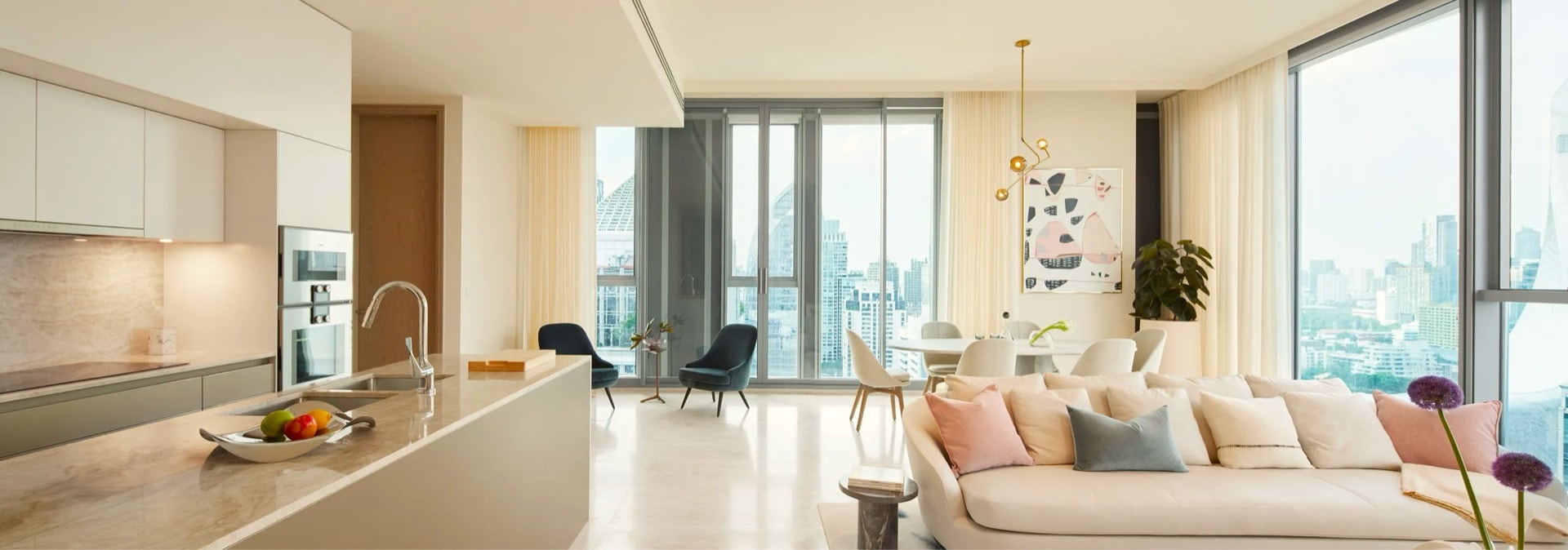 Open-plan kitchen and living room with a skyline outlook in a Scope Langsuan residence