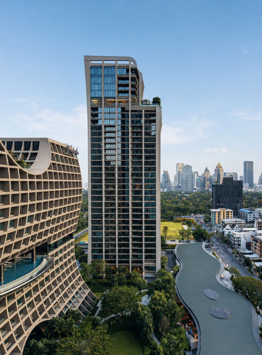 The Residences at Sindhorn Kempinski: the residential tower beside the curved Sindhorn Kempinski hotel and Lumphini Park in central Bangkok