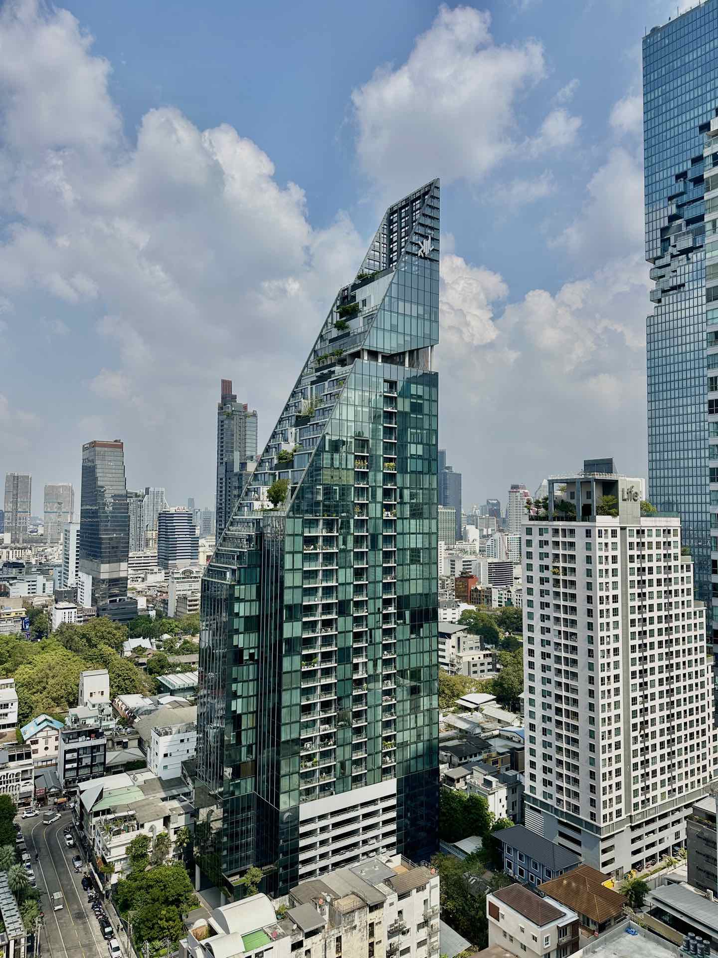 Tait Sathorn 12: the tower's angular crown seen above the Sathorn skyline