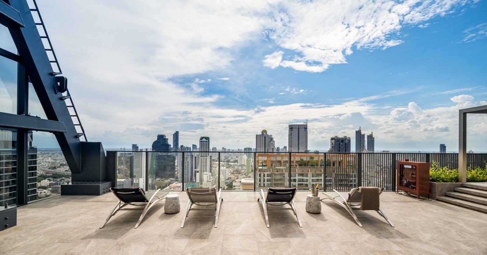 Tait Sathorn 12: rooftop terrace with loungers and skyline view