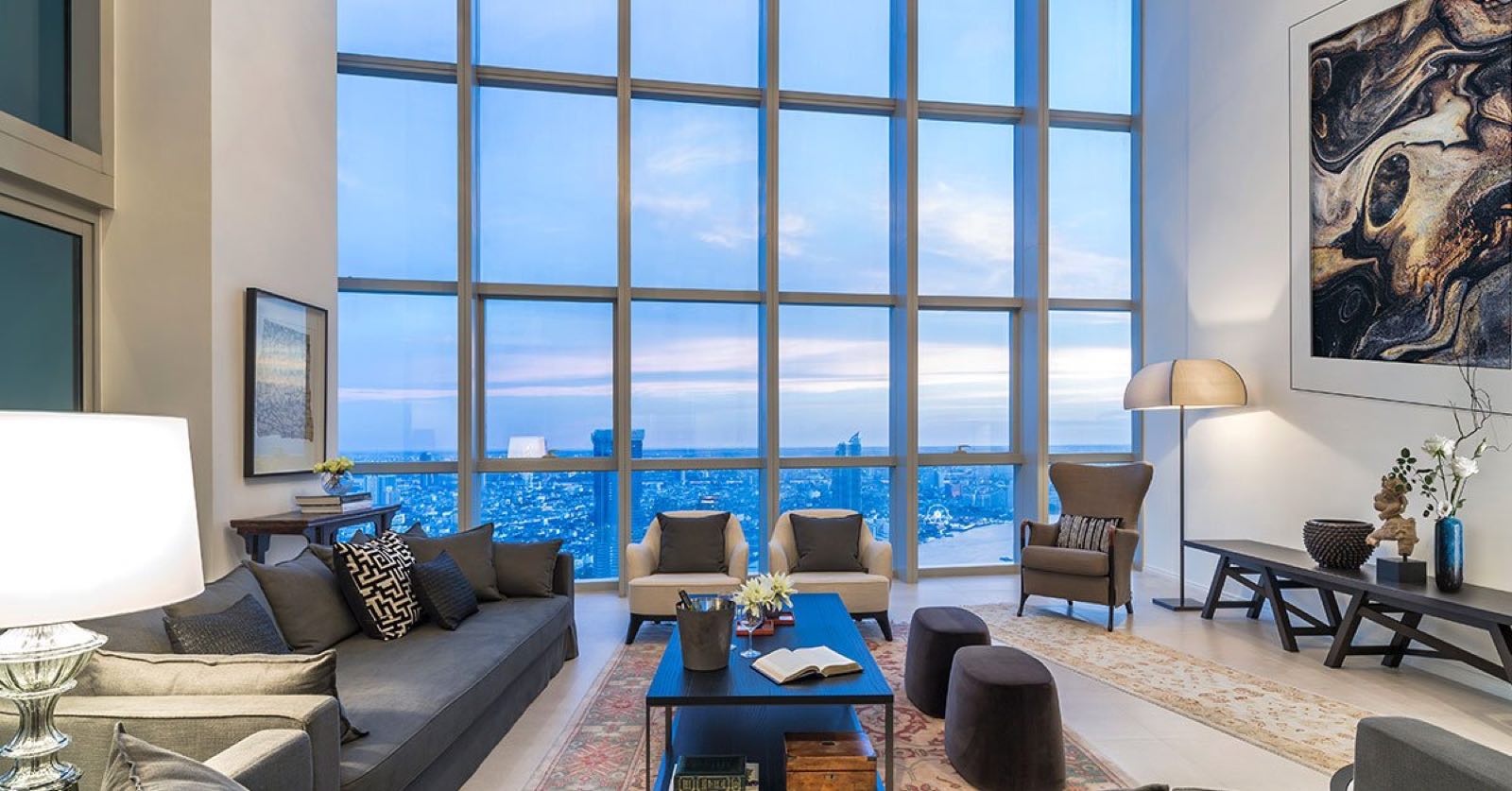 The River: double-height living room with floor-to-ceiling river view