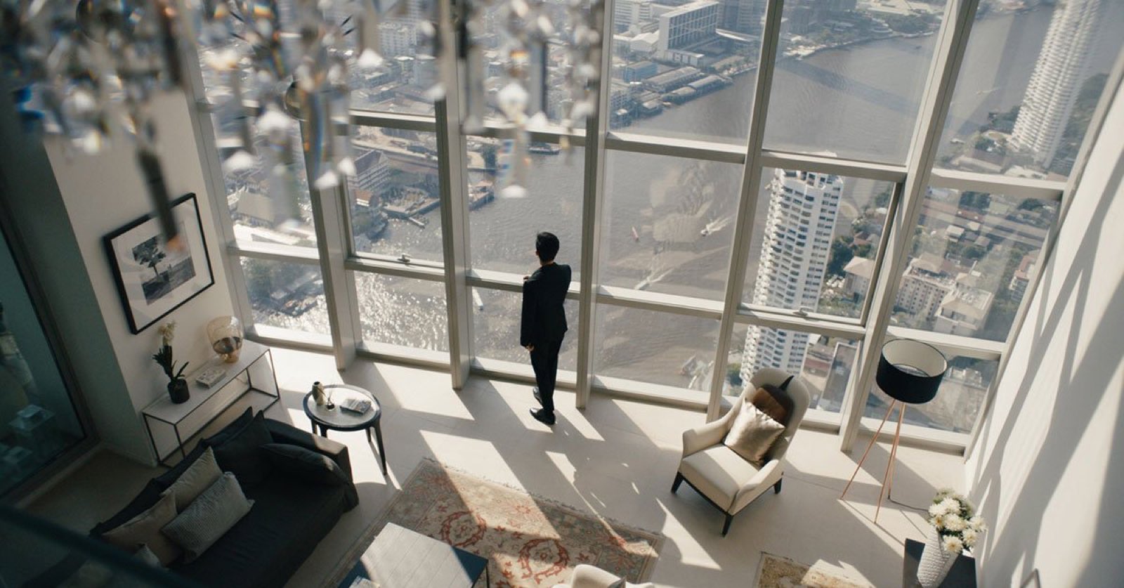 The River: double-height penthouse living room with river panorama