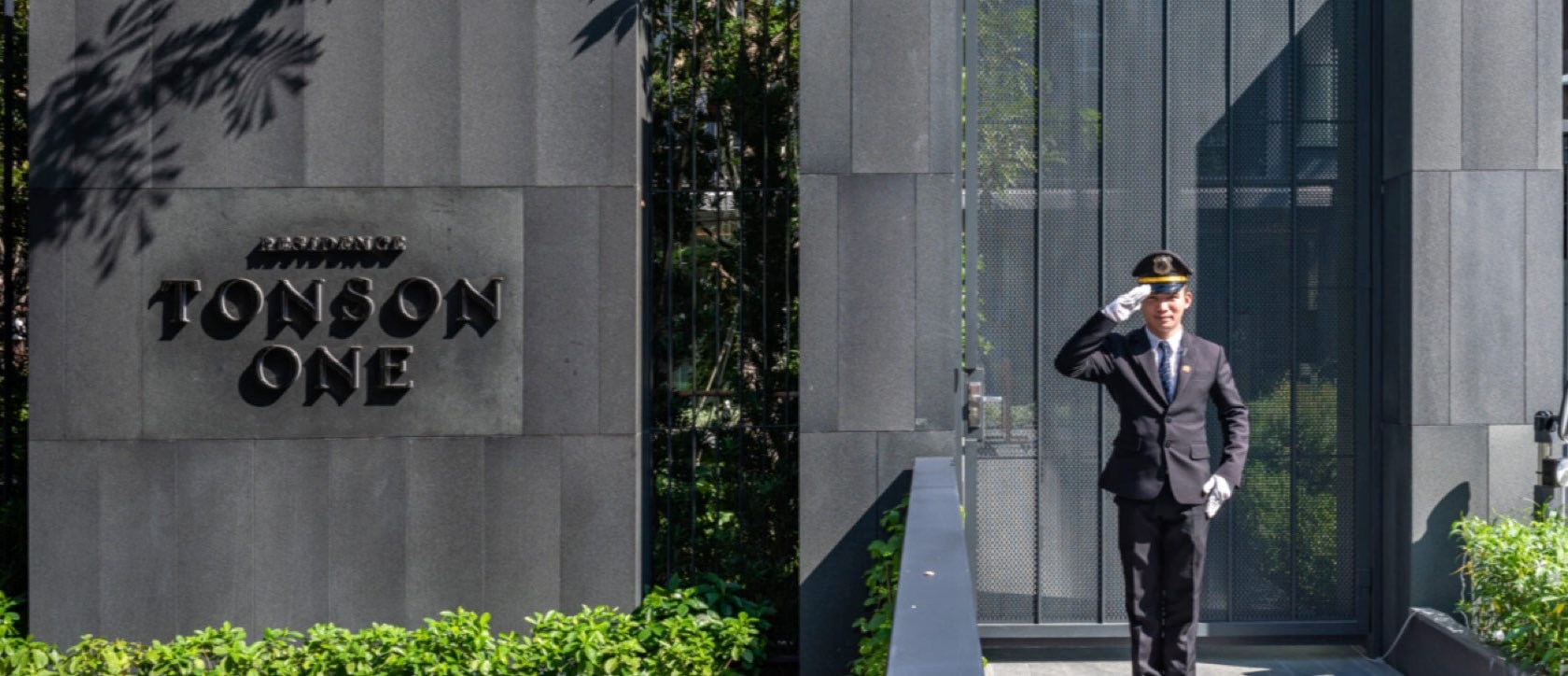 The Tonson One residence entrance signage and doormen at arrival on Tonson Lane, central Bangkok