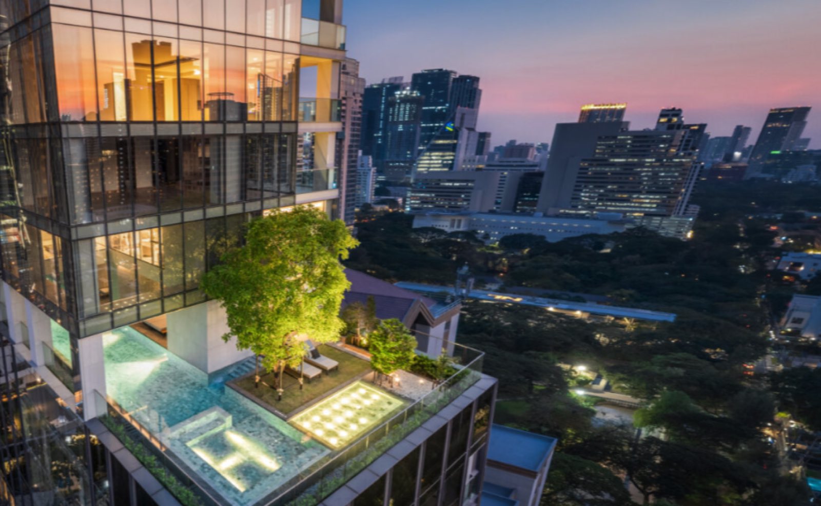 The rooftop sky garden and reflecting pool at Tonson One overlooking Lumphini Park at sunset