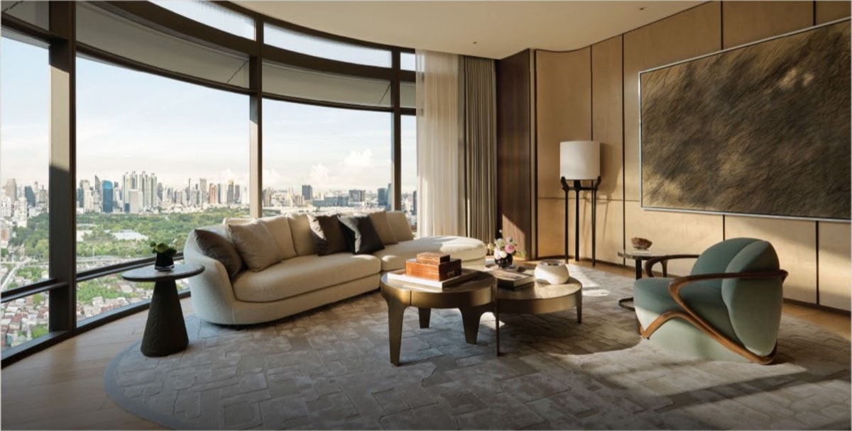 Curved living room with park and skyline views in The Wireless Residences by Upper House, interiors by PIA Interior