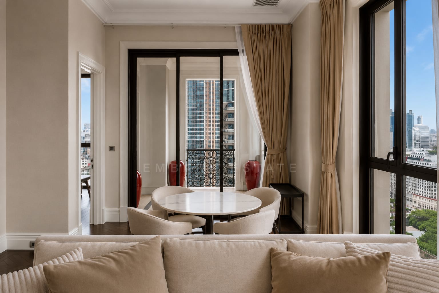 The dining table at 98 Wireless seen over the sofa, French doors opening onto the wrought-iron balcony