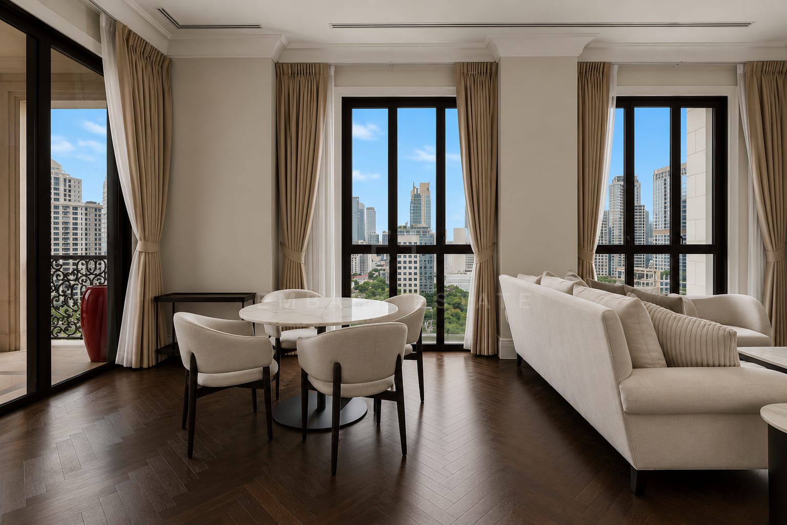 The living and dining room at 98 Wireless from the corner, the marble table beside the sofa with the balcony beyond