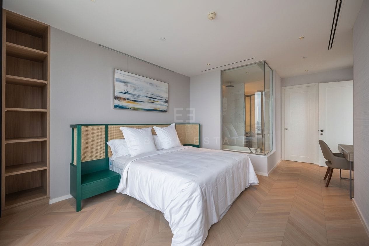 Four Seasons Private Residences Bangkok — master bedroom with rattan headboard and the bathroom behind glass