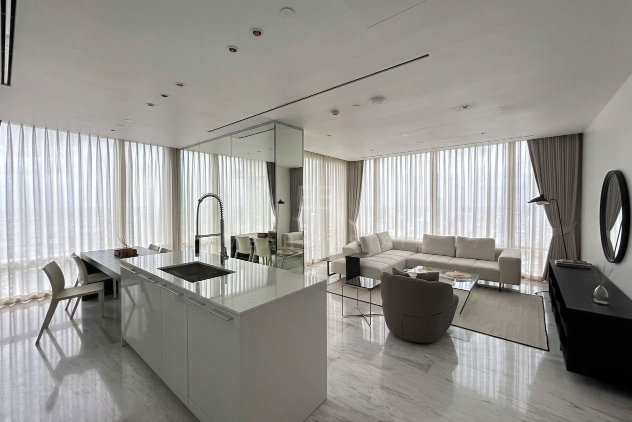 Four Seasons Private Residences Bangkok — kitchen island and living area with sheer curtains
